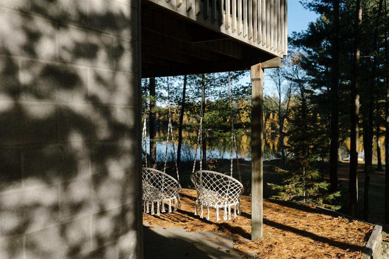 Hanging chairs under the deck with lake view
