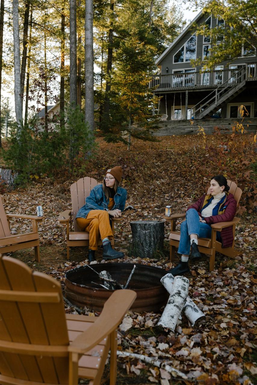 Fire pit gathering with cabin in background
